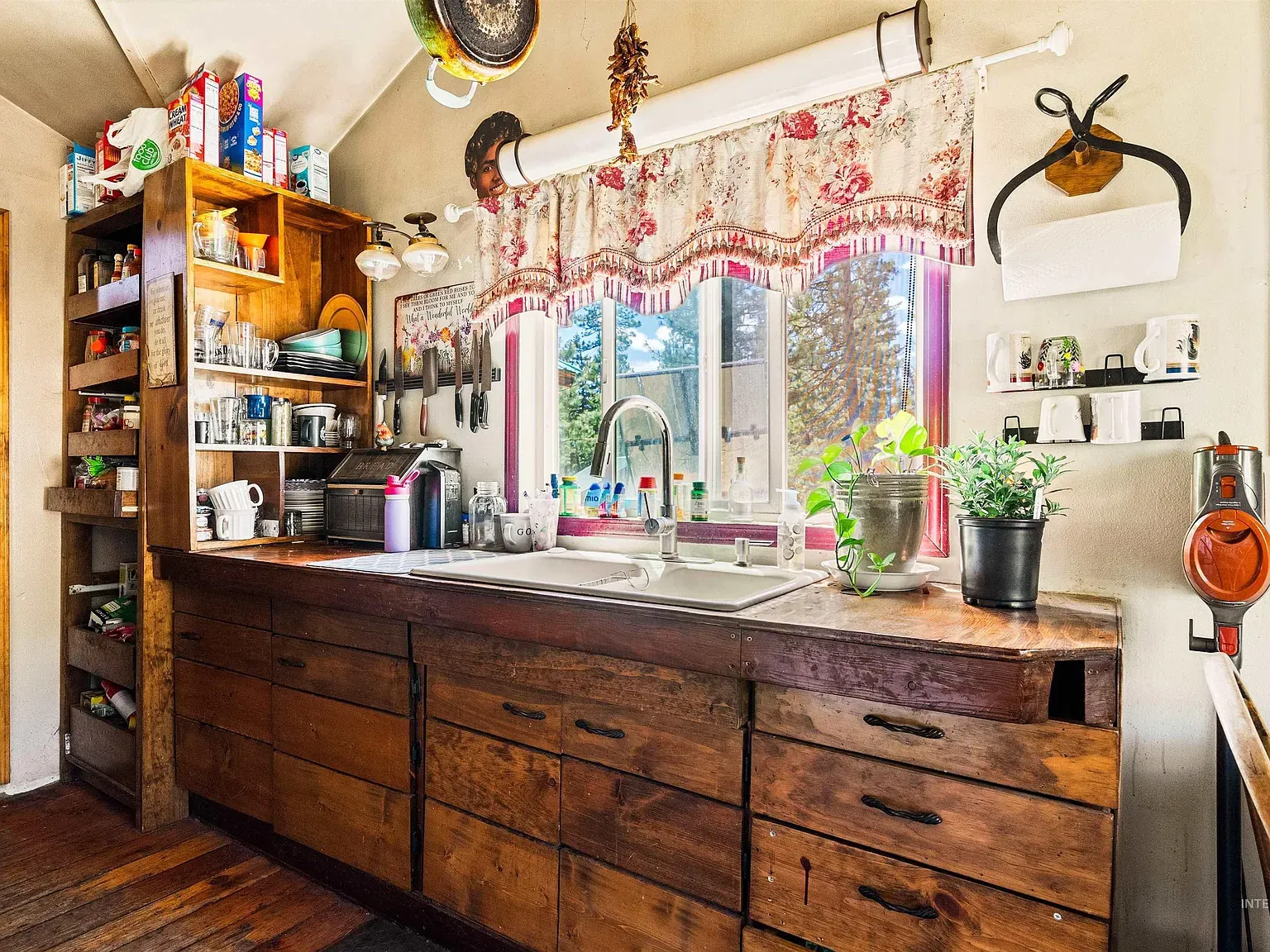 Wide dark wood counter with mismatched, well worn cabinets.
