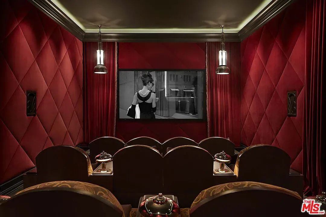 Here's the theater. red tufted walls, moody ceiling. Feels vintage luxe.
