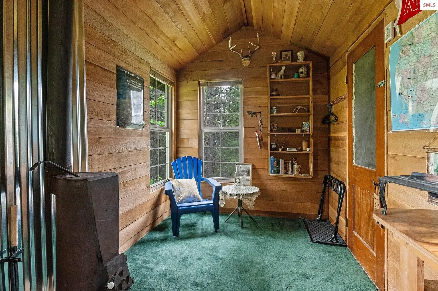 ## Wood walls, a sloped ceiling, and big windows pouring in light—yeah, inviting.