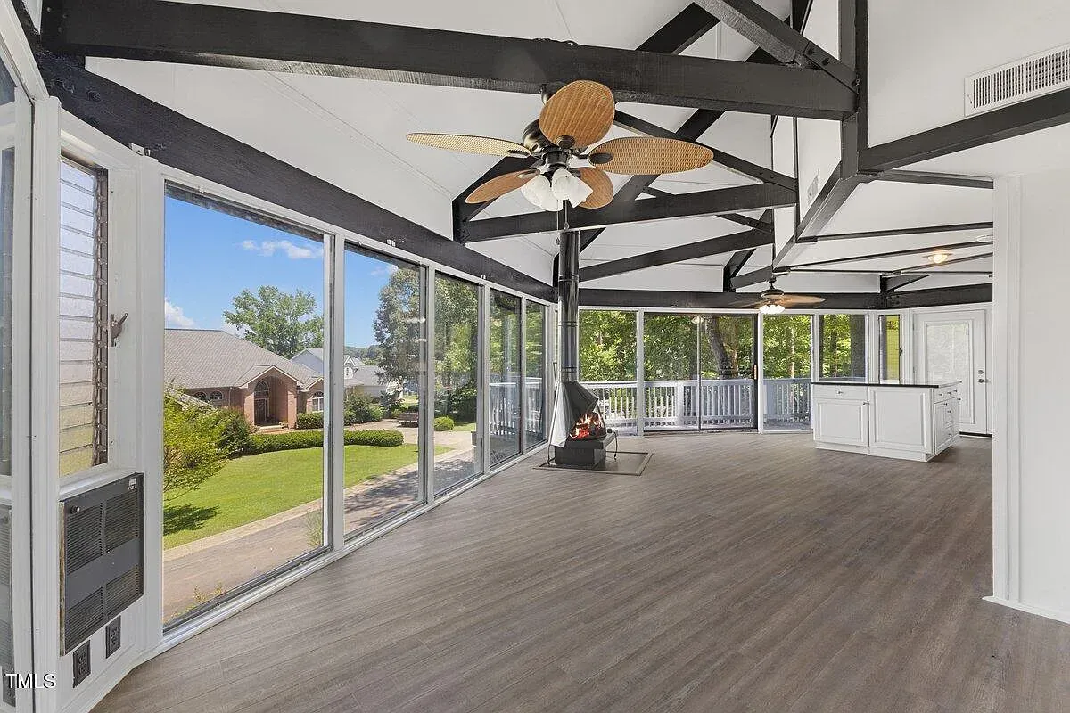 ## The next sunroom opens even wider—glass walls, gleaming wood floors, and views that stretch out like a living postcard