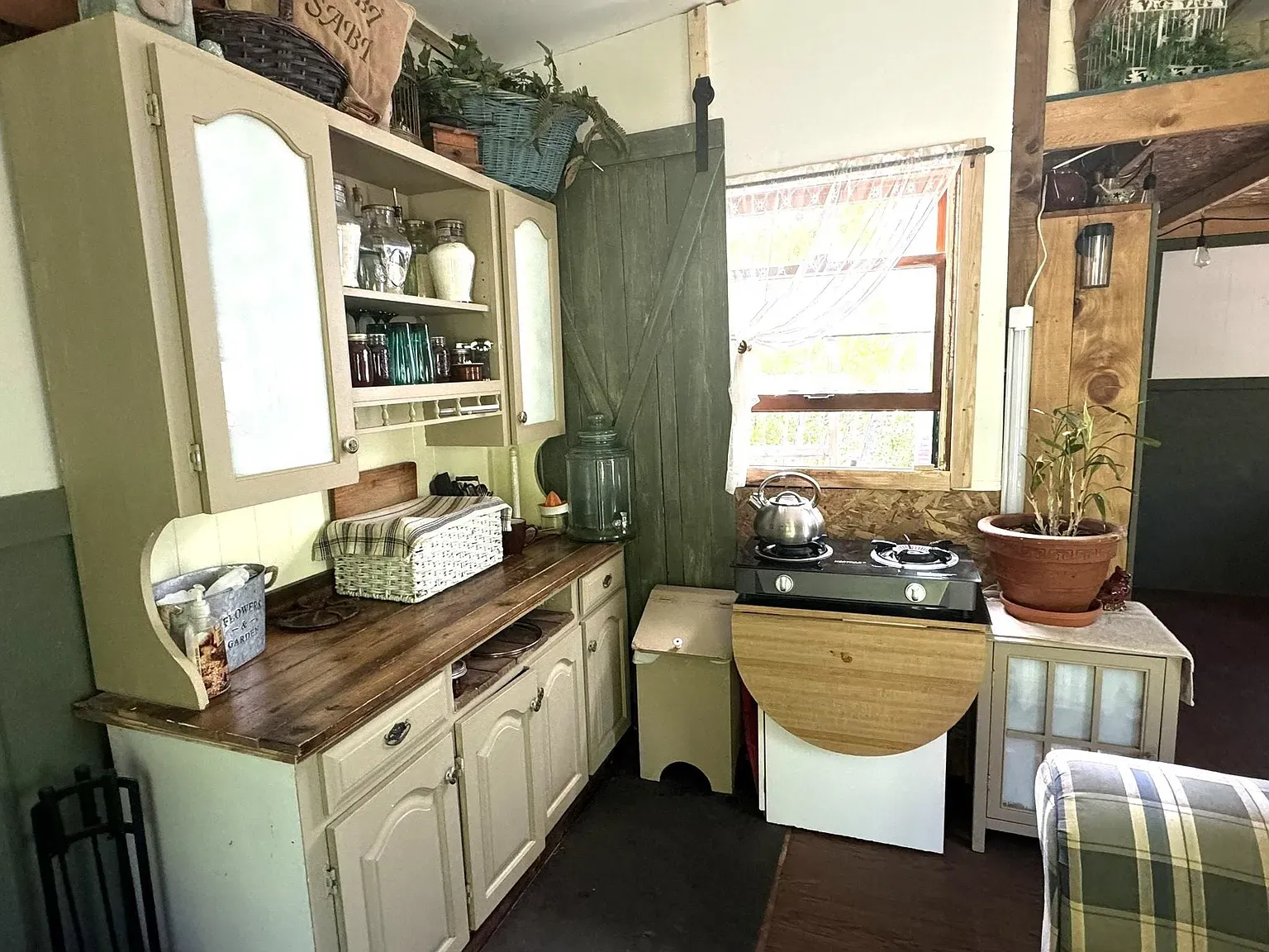 Kitchen time. cream cabinets, chunky wood counter. I mean, cute, maybe a bit much?