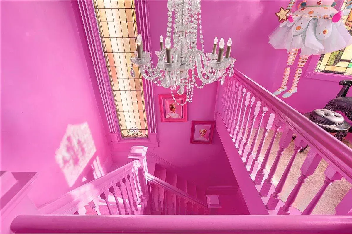## Down the bold staircase, hot pink wraps every inch; it’s loud, playful, and honestly pretty thrilling between floors.