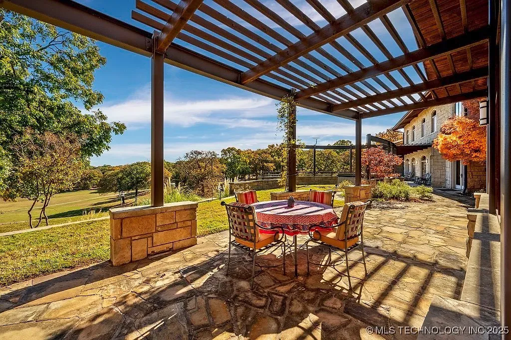 Pergola patio — dappled shade, comfy seating, I’d live here.