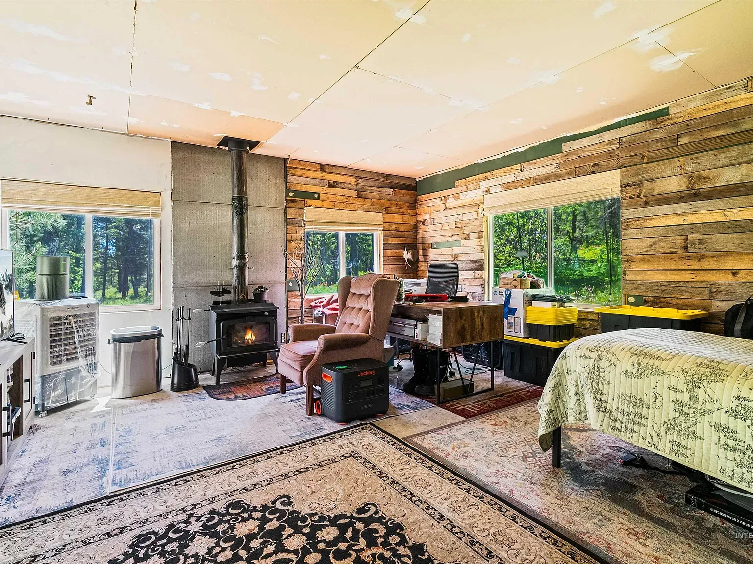 Patchwork reclaimed wood on the walls, rough ceiling. Feels handy.