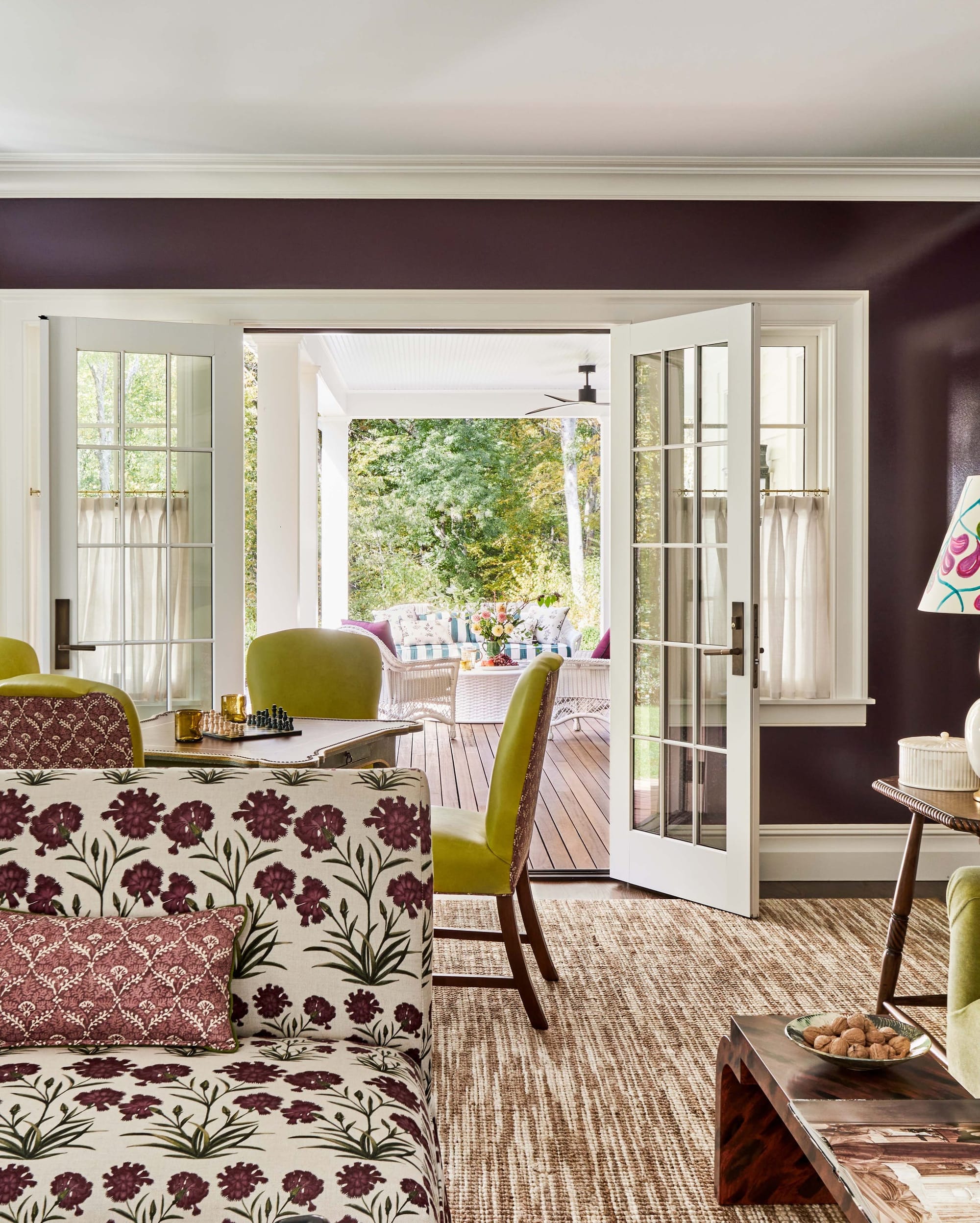 "Seamless Indoor-Outdoor Living: French Doors Open to a Lush Sunlit Porch Perfect for Year-Round Entertaining!"