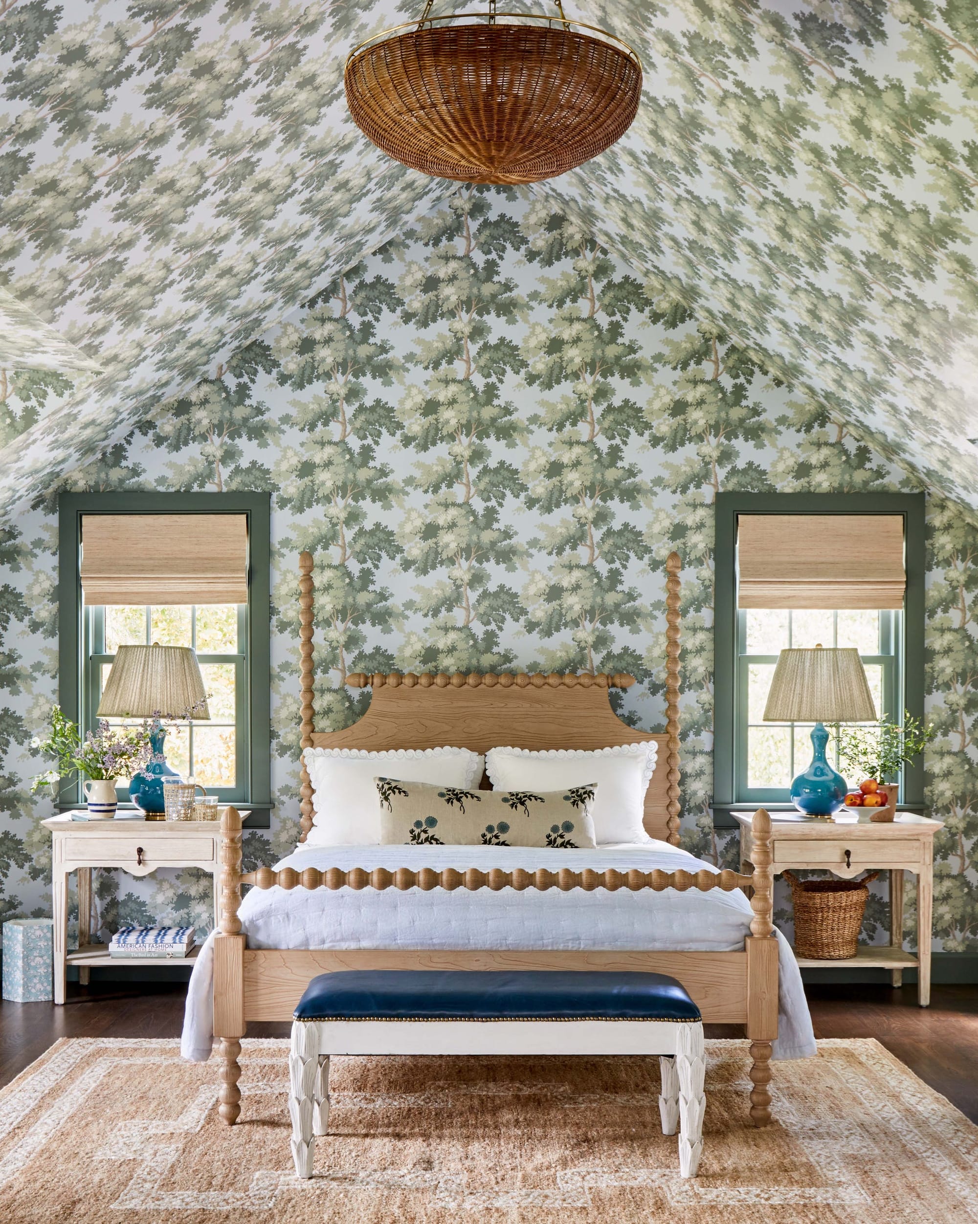 "A charming woodland retreat comes to life in this cottage bedroom with stunning tree-patterned wallpaper and natural wood accents!"