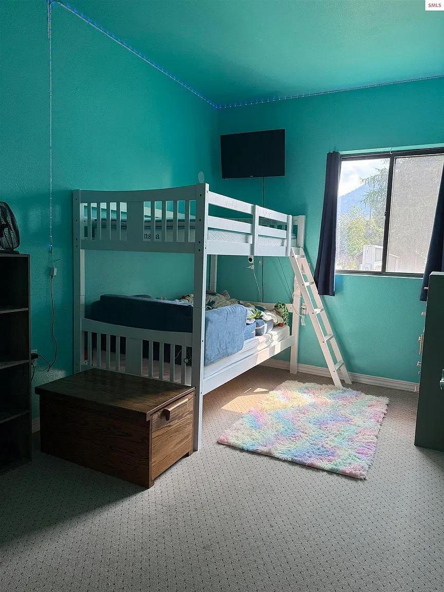 Kids’ room goes full turquoise with a white bunk. Play fort energy.
