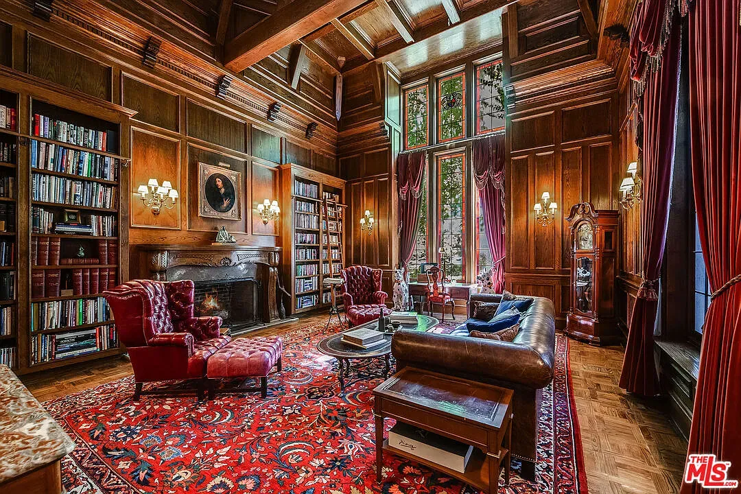 Okay, this living room—dark paneling, coffered ceiling, rug doing the most. Too much?