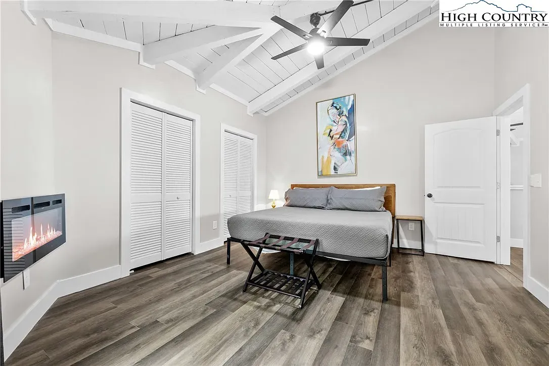 ## Another bedroom leans rustic-modern—exposed beams and light floors keep it serene.