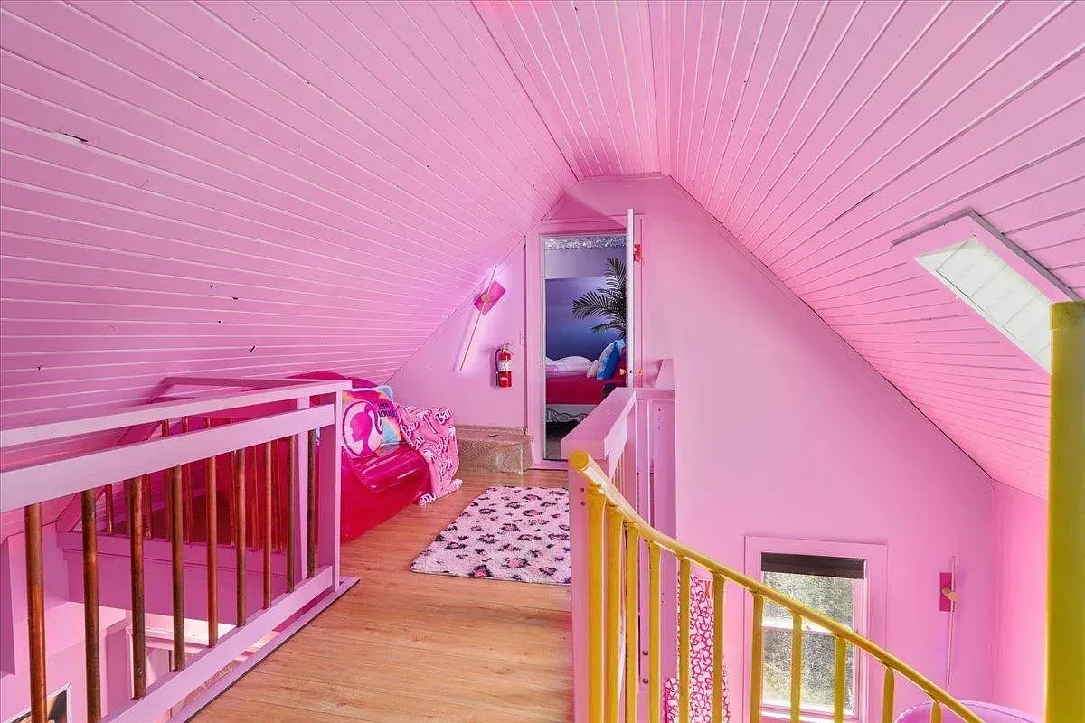 ## Soft pink tongue-and-groove climbs the slopes overhead, giving this nook a sweet, cabin-like vibe—simple, warm, and very photogenic.
