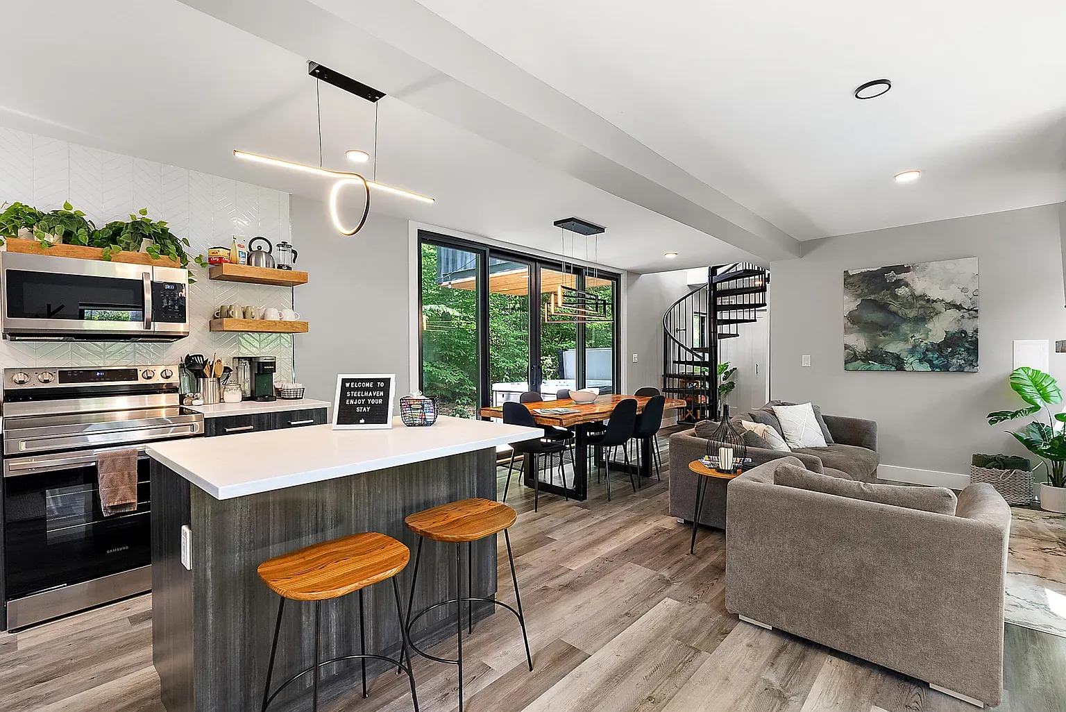 Dining and kitchen together, all neutrals. Subtle wood, matte black fixtures, feels calm.