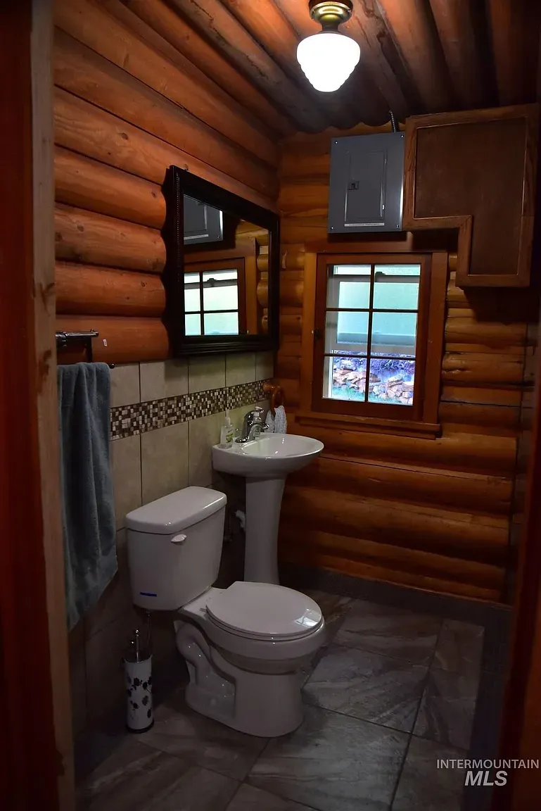 ## Rich, warm-toned logs set a soothing rhythm—every surface humming with that close-to-nature calm.