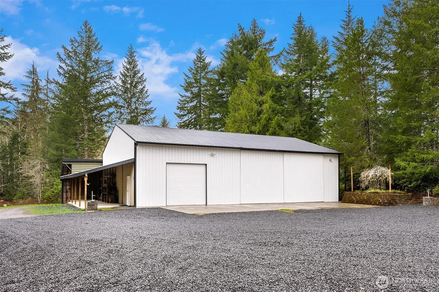 And then a white steel building with a sharp gray gable. Storage?