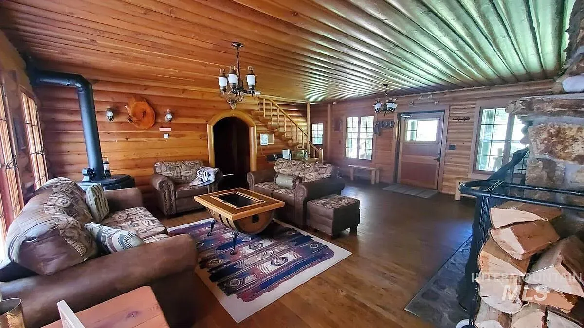 ## Exposed beams span overhead; layered wood tones gather below, making the whole room feel grounded and alive.