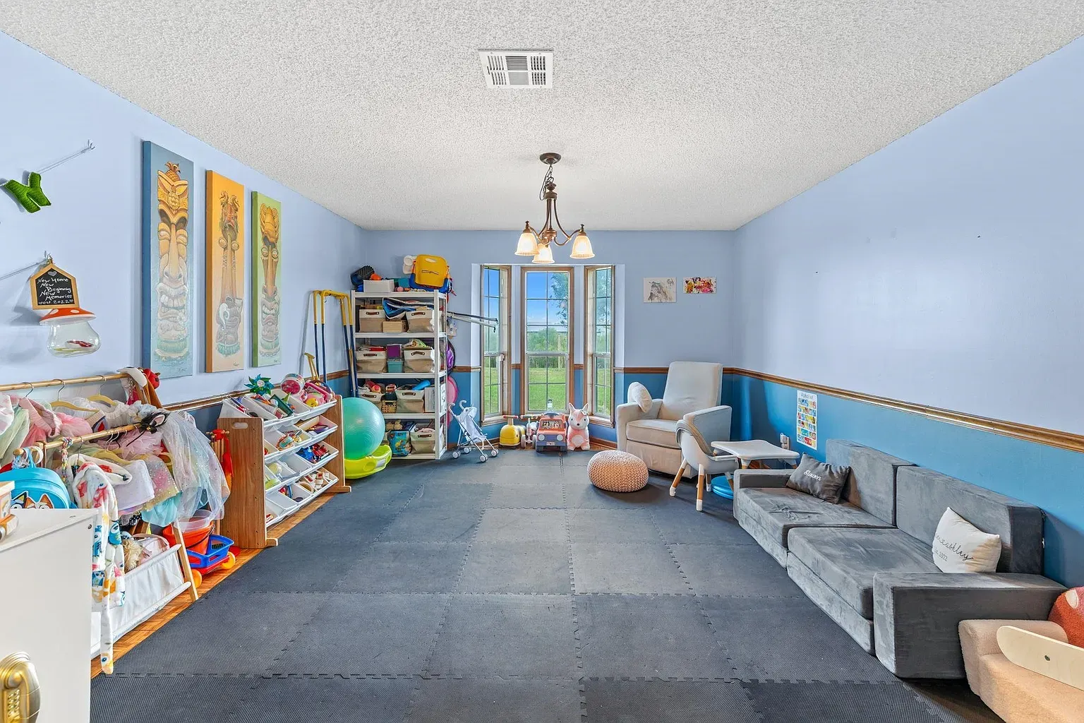 Playroom with padded tiles. Kinda gym-meets-nursery, smart for tumbles.