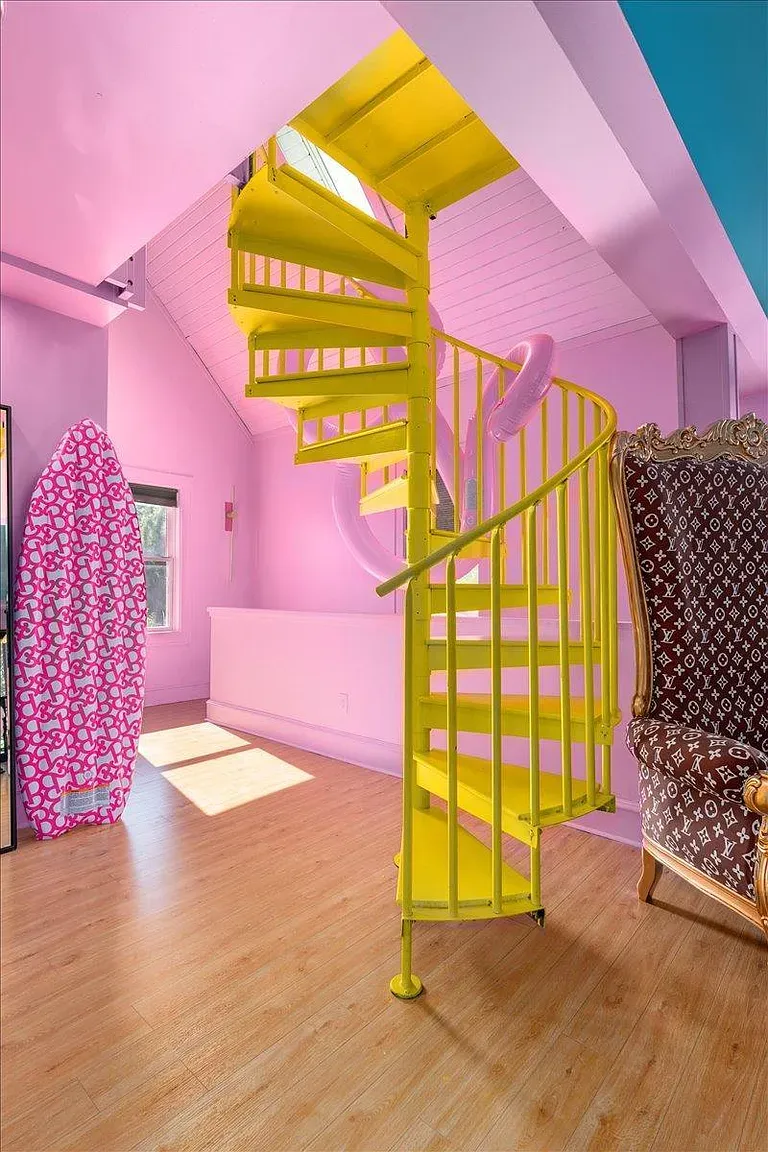 ## Soft pink walls set a cheerful tone, and a playful centerpiece anchors everything—feels like a creative studio waiting for your next idea.