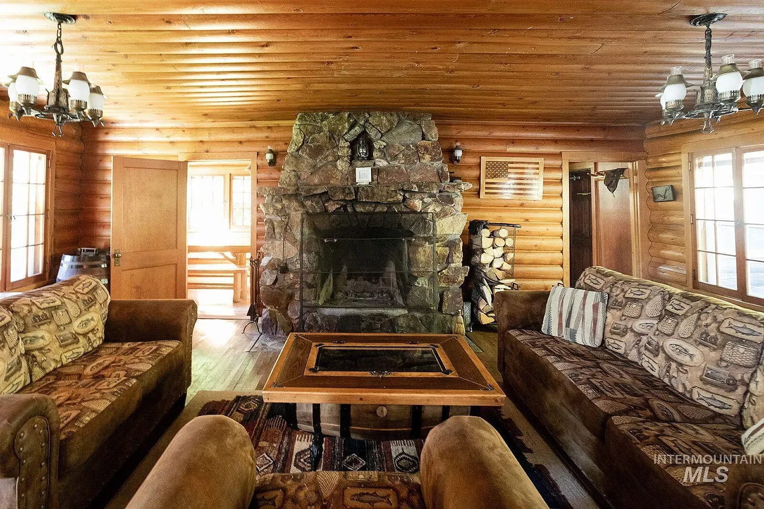 ## Warm wood everywhere, then that rugged stone hearth takes center stage—bold, weighty, and made for lingering eyes.