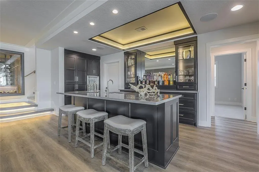 Home bar is moody and slick. Not sure about the gray top with black.