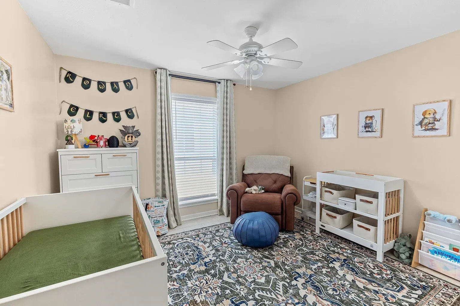 Soft beige nursery, big window, breezy curtains. Calm little spot.