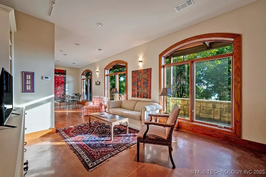Living room with cathedral windows. Beige walls keep it soft, not fussy.