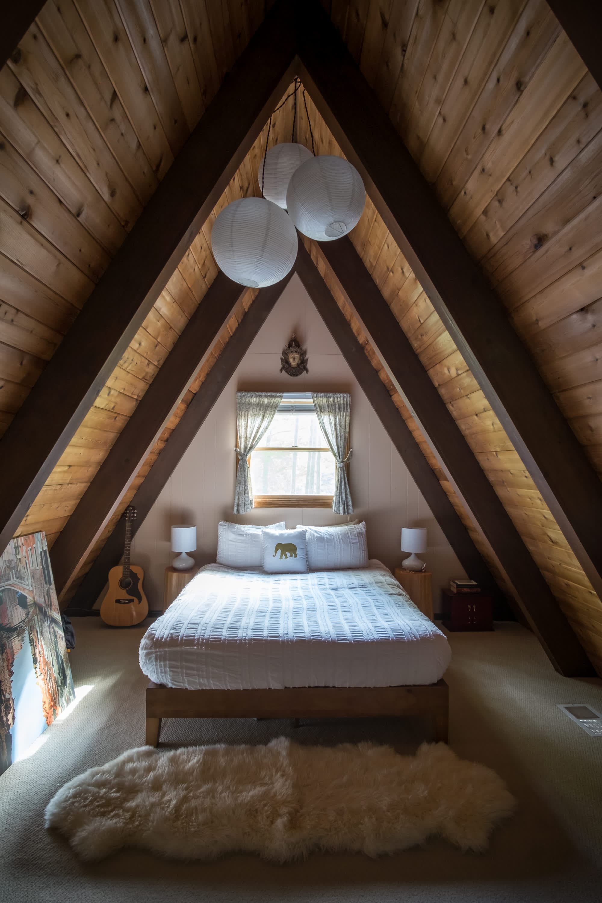 "Cozy A-frame loft with rustic charm and dreamy paper lanterns!"
