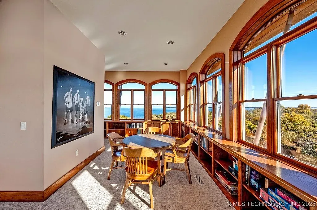Here’s that corner view — arched windows, built-ins, sunlight just pours in.