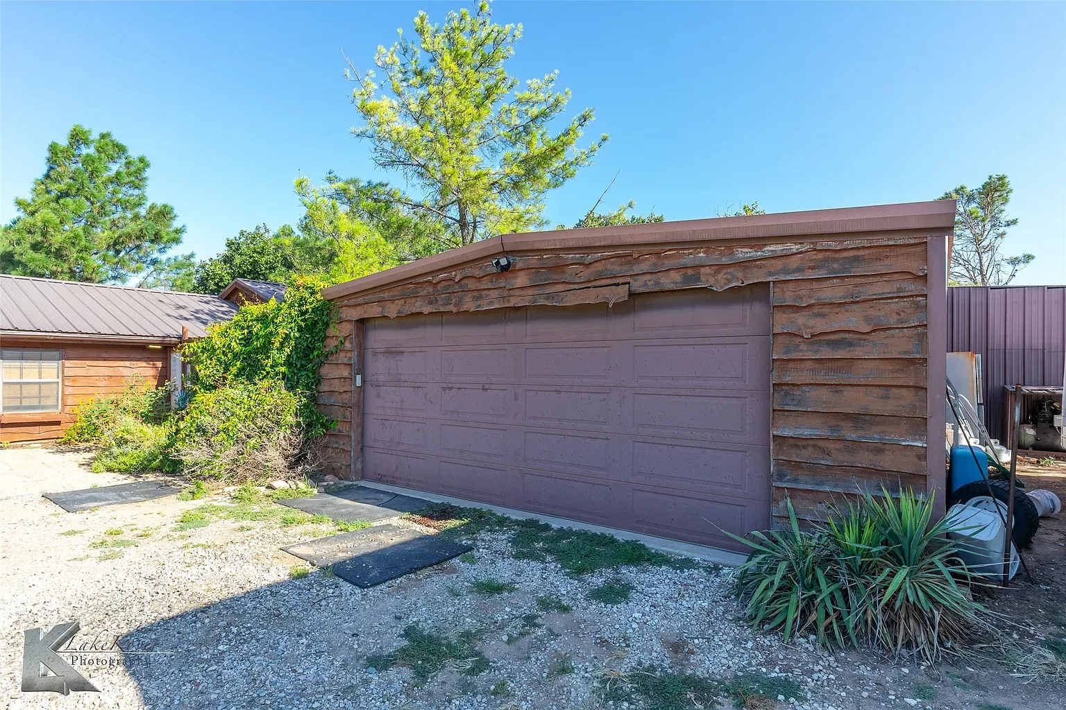 This garage looks straight out of a western. Gorgeous wood, kinda leans barn.