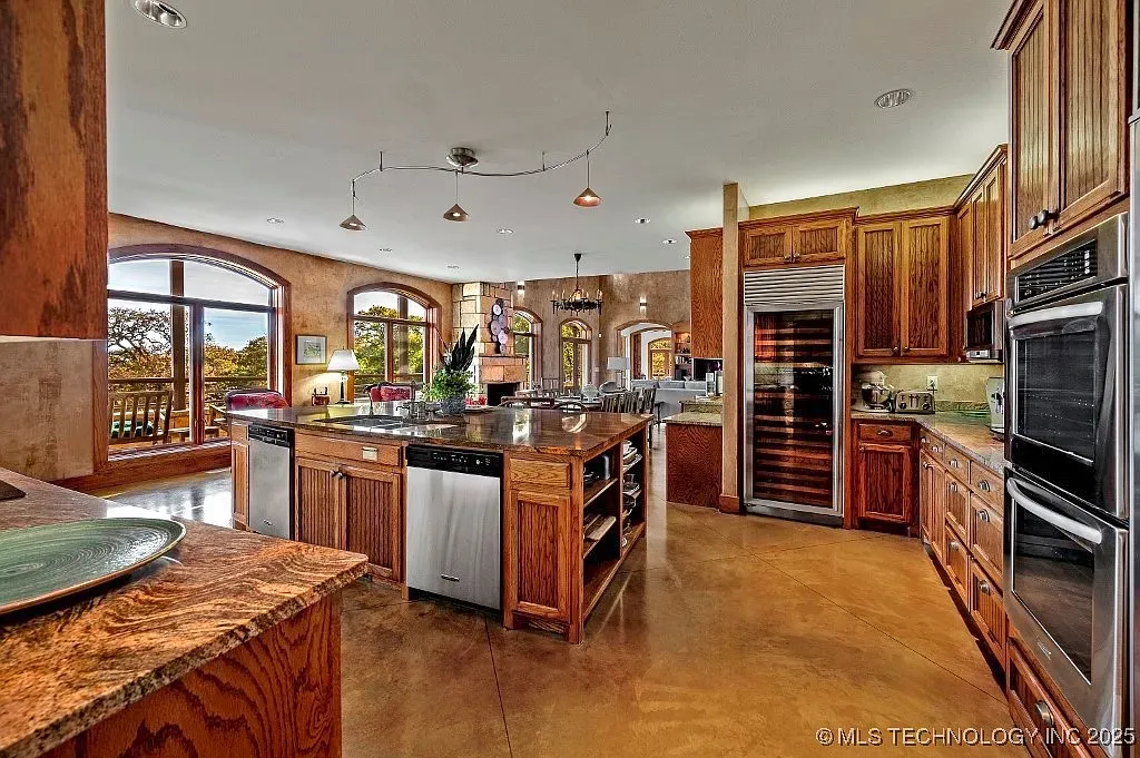Here’s the other kitchen angle — chunky wood cabinets, glossy stone, serious appliances.