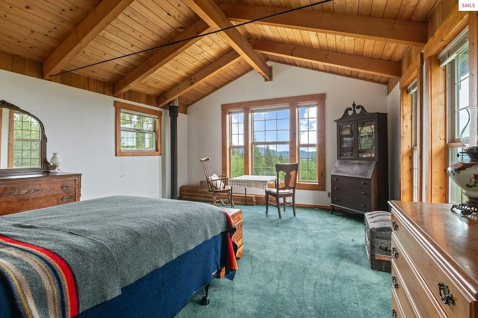## Vaulted ceiling, dark beams over light paneling—nice contrast. Soft walls keep it calm.