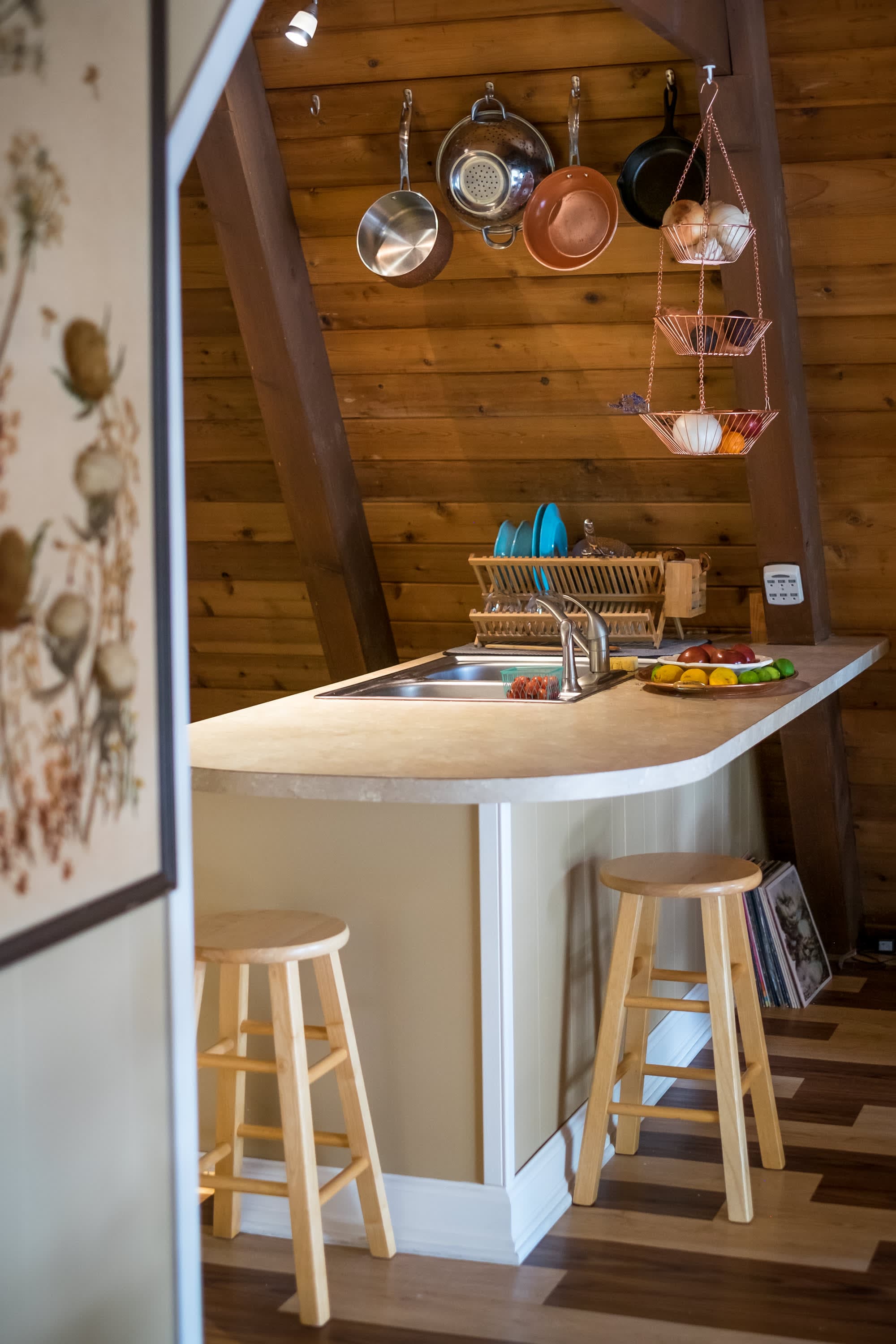 "Cozy A-frame kitchen with rustic charm and clever storage!"