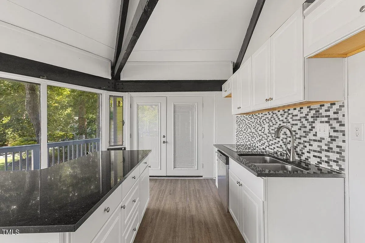 ## Next stop, the modern kitchen—big dark-granite island, clean white cabinetry, tons of storage. I could cook here for hours