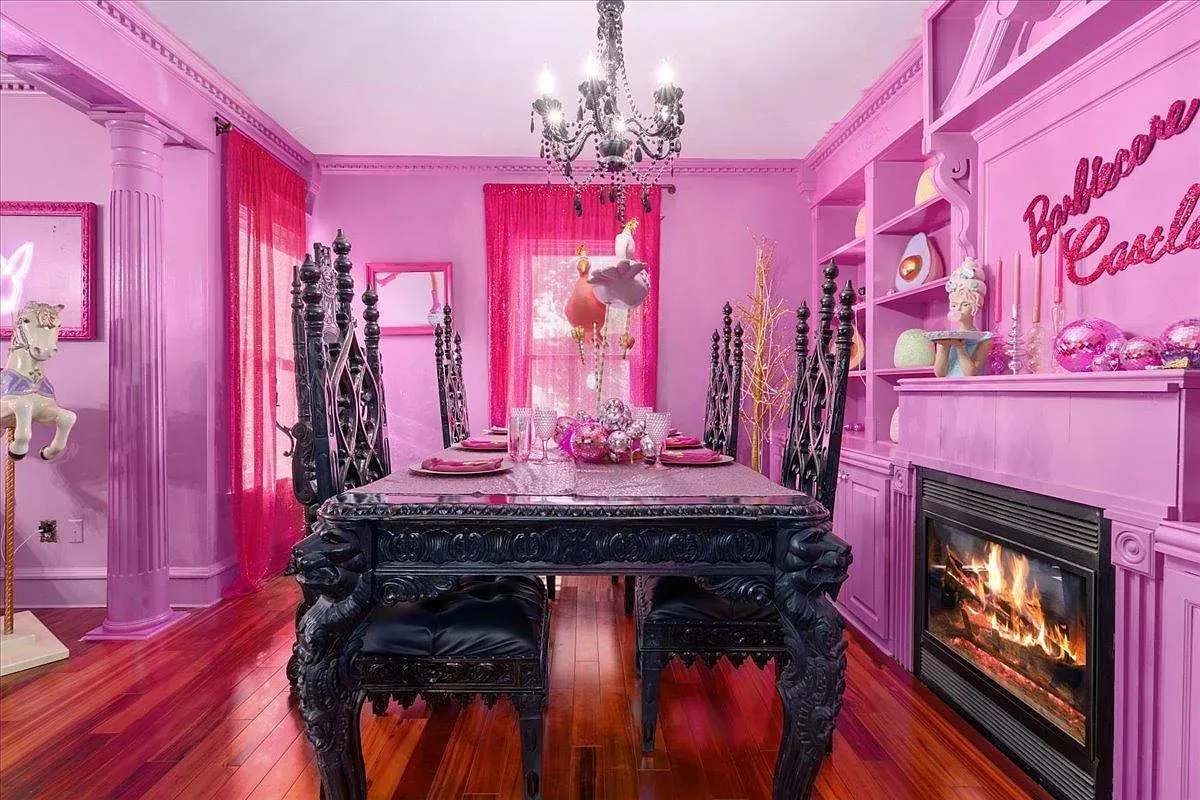 ## Hot pink dining room frames the table with classic picture molding; dinner here would feel like a party before the appetizers arrive.