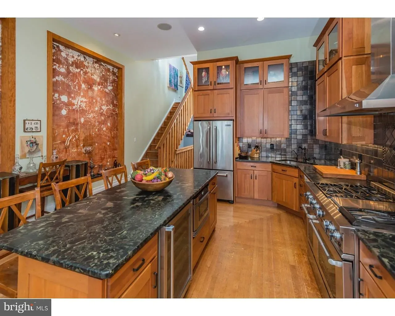 Here’s the kitchen—dark granite island, honey cabinets. Feels solid without being stodgy.