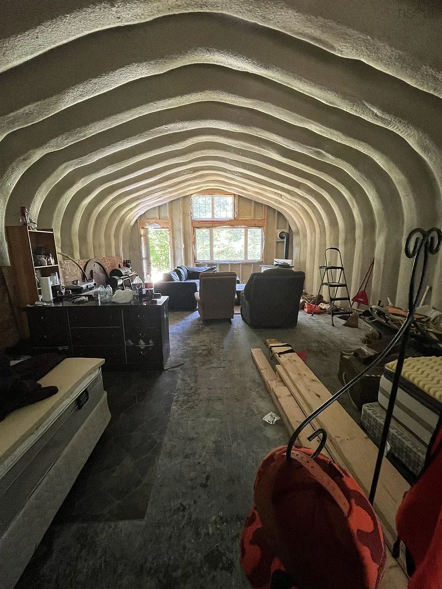 Inside now — wavy ceiling doing ocean cosplay. Plaster texture, soft light feels calm.