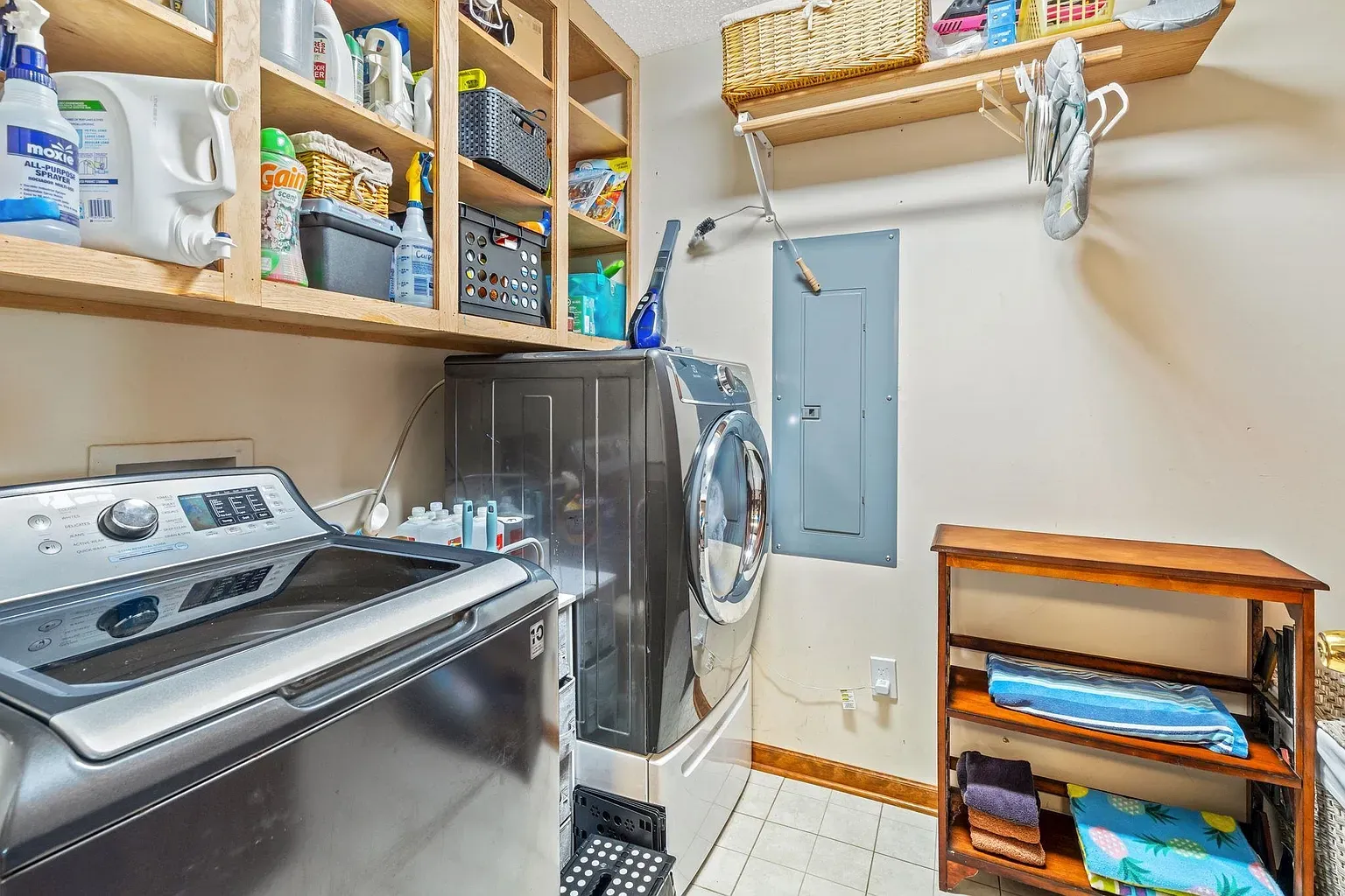 Here's the laundry — beige walls, modern machines, decent counter space.