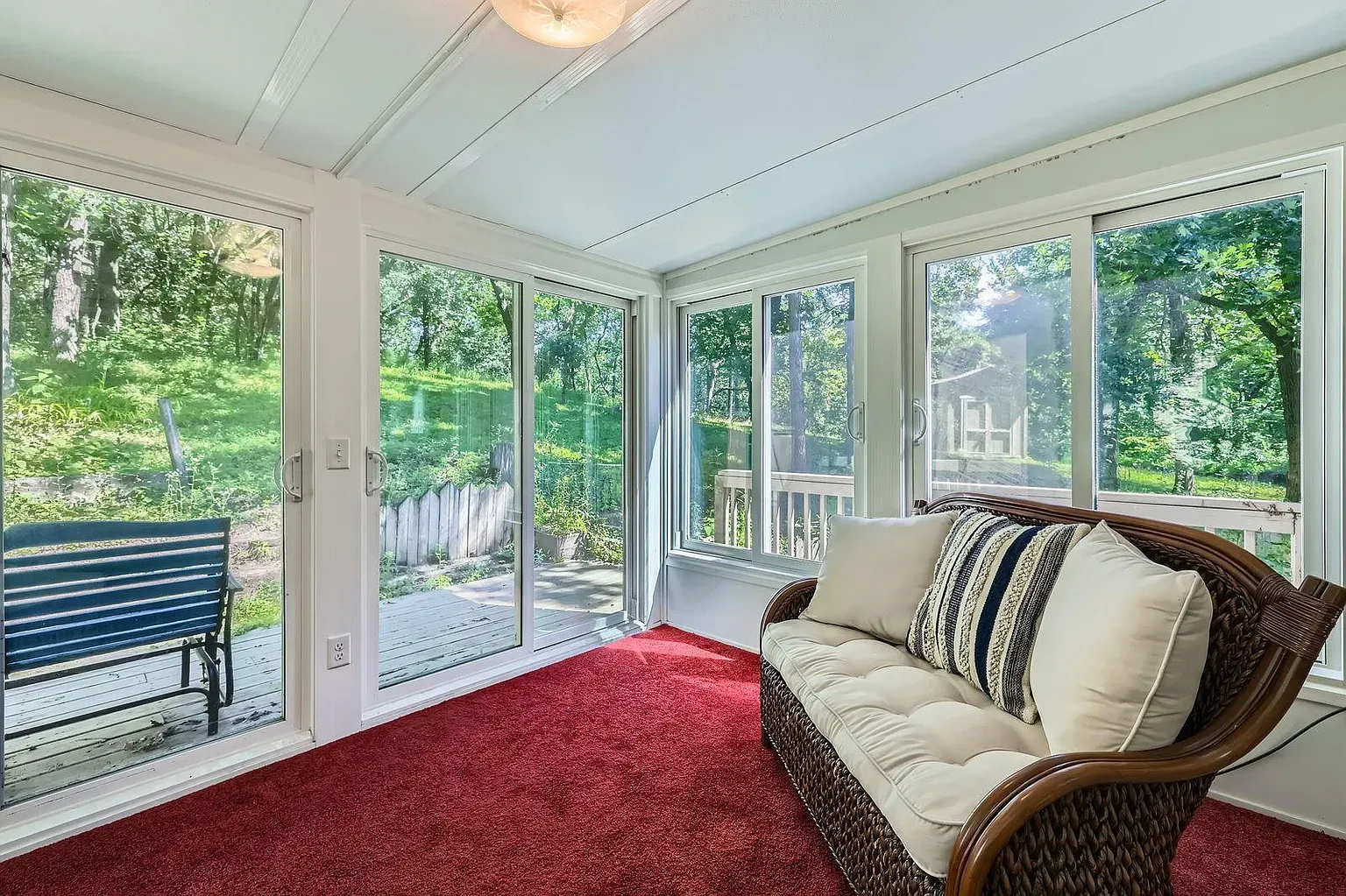 Sunroom goals—glass on three sides, feels sitting in the trees. Heated?