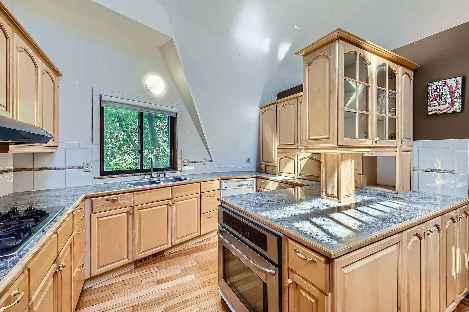 Another kitchen, lighter wood cabinets, classic lines. Not sure about the hardware.