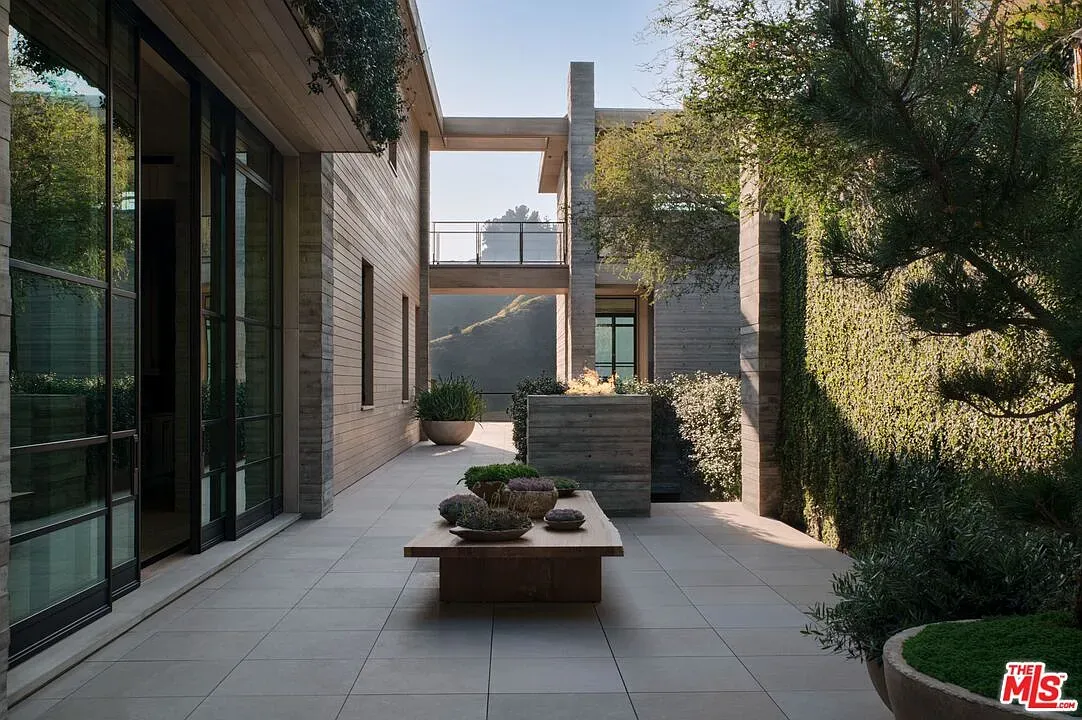 Courtyard reset. big stone slabs, greenery tucked around. Quiet little pocket.