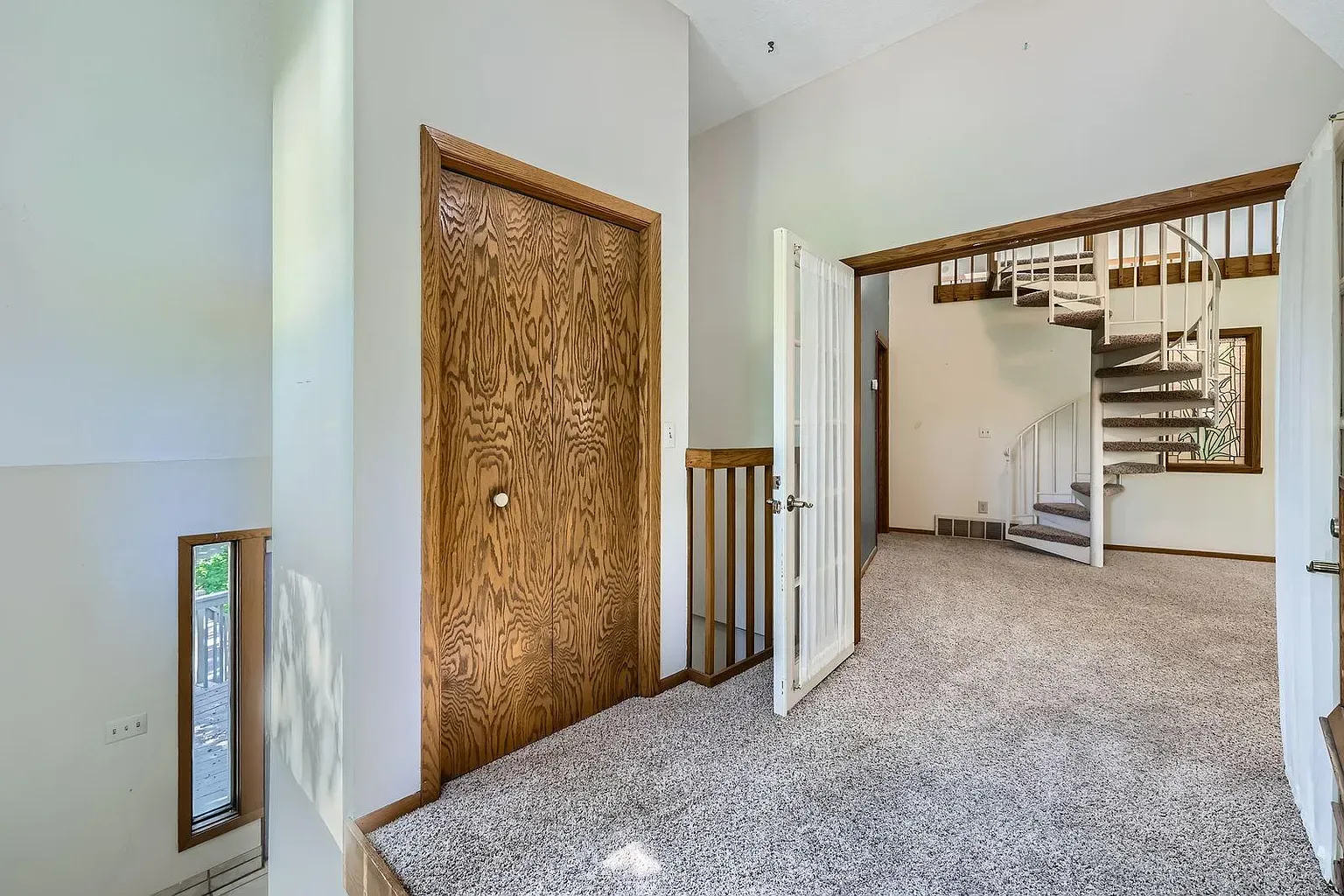 Entryway looks comfy—neutral walls, plush beige carpet. Shoes off, obviously.