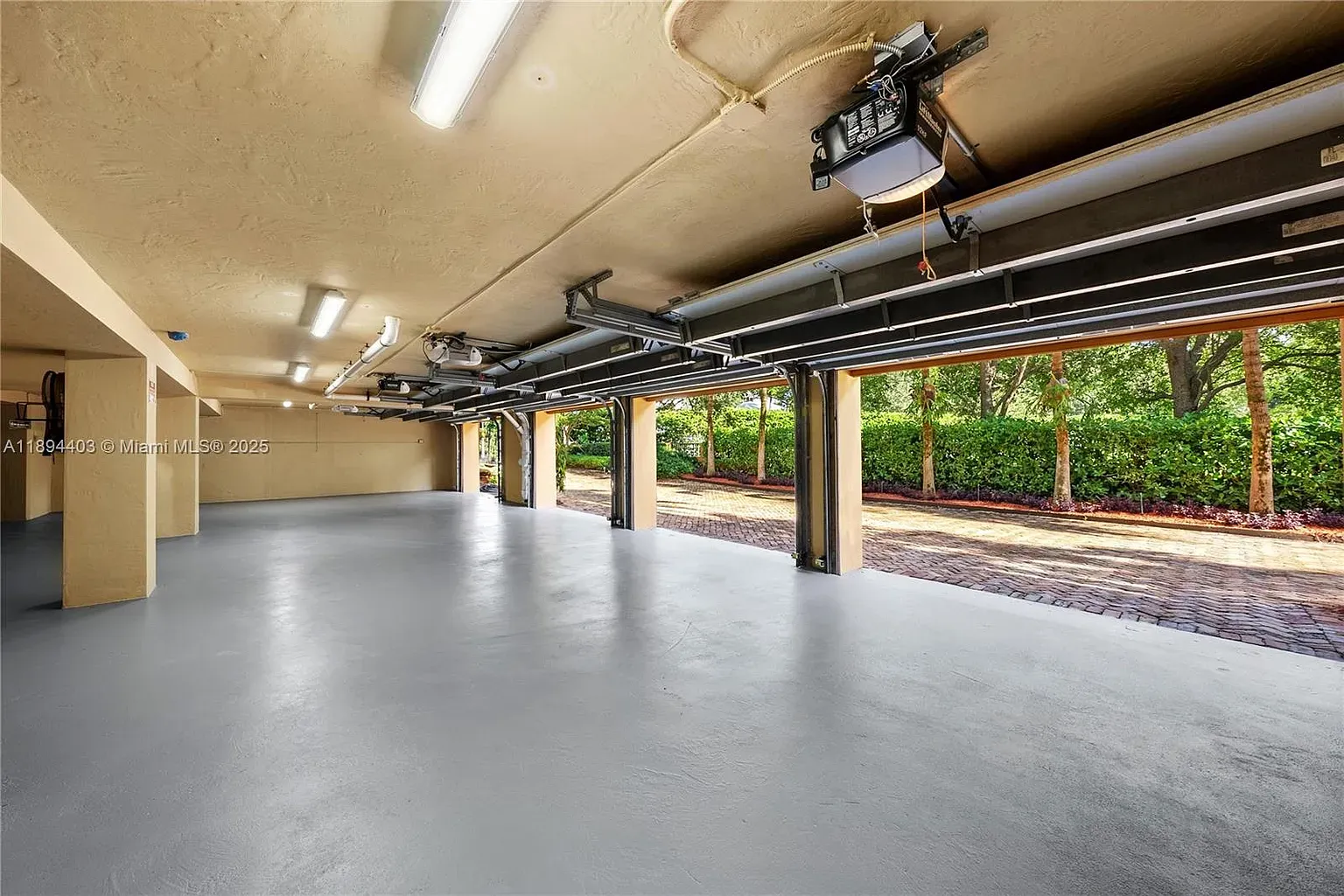Garage is spotless—epoxy floors, high ceiling. Workshop dreams activated.