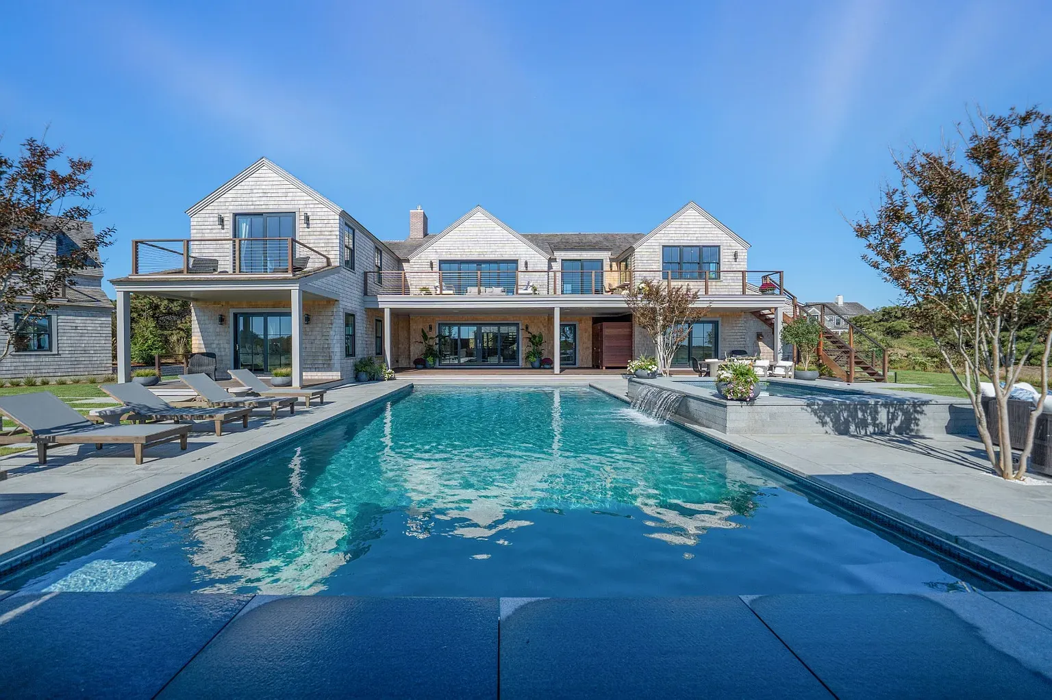 Back outside—light gray shingles, tidy lines, windows lined up soldiers.