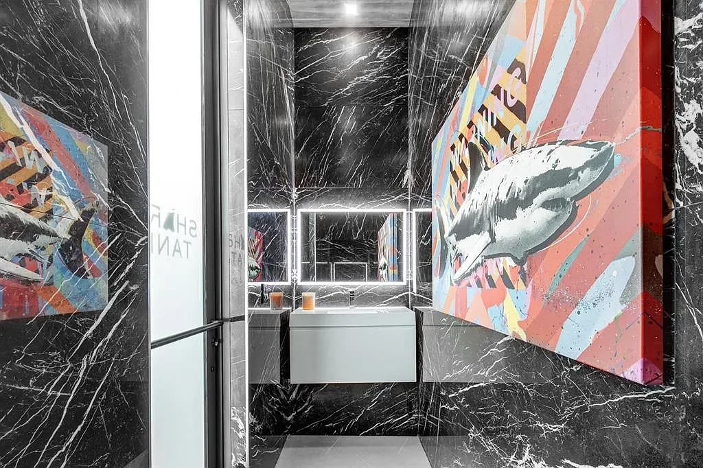 Black marble cave vibes, with a pop of art. Dramatic in a good way.