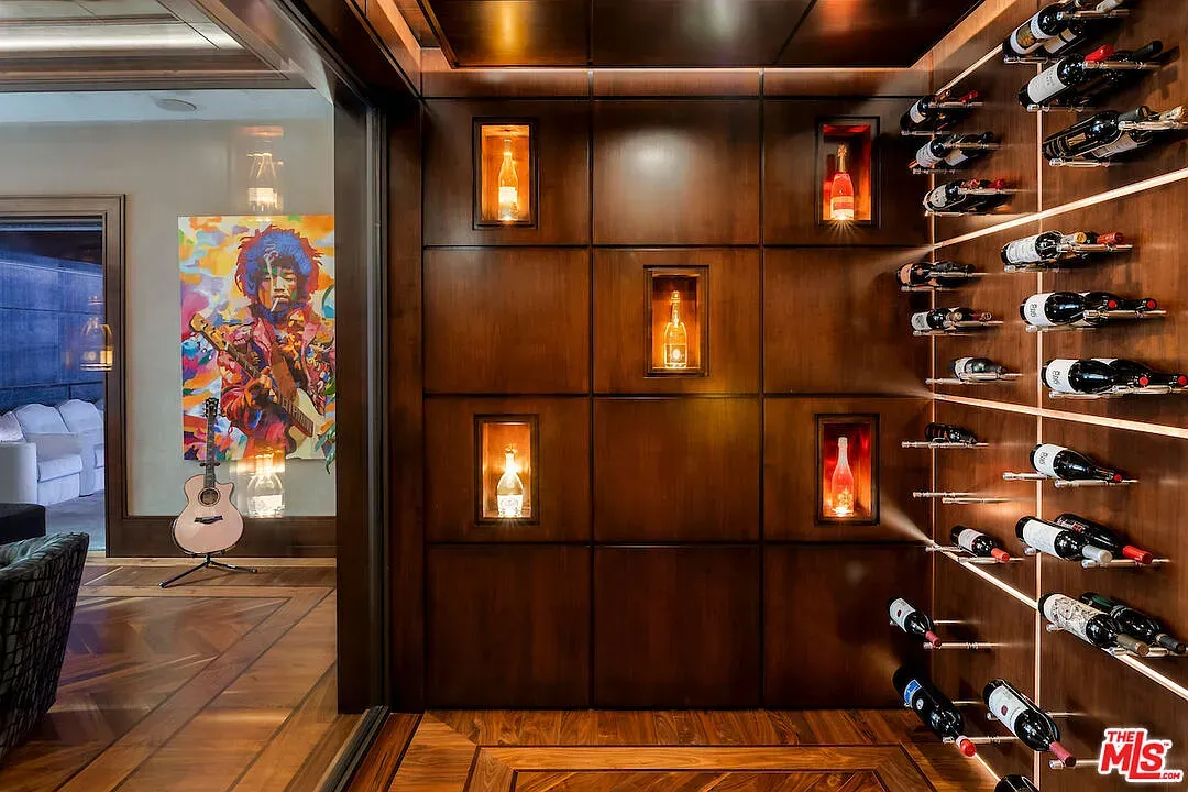 Wine vault with art. Labels facing out soldiers. Sommelier breathing intensifies.