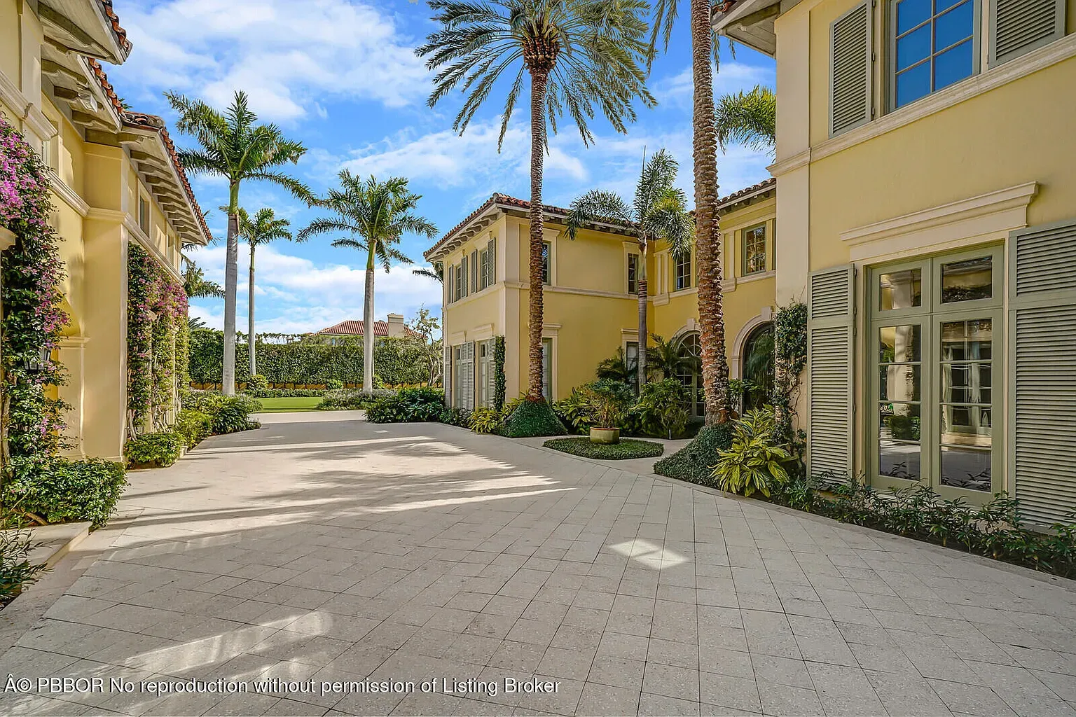 Back outside, the courtyard's buttery walls with palms. Kinda resort-y, not mad.