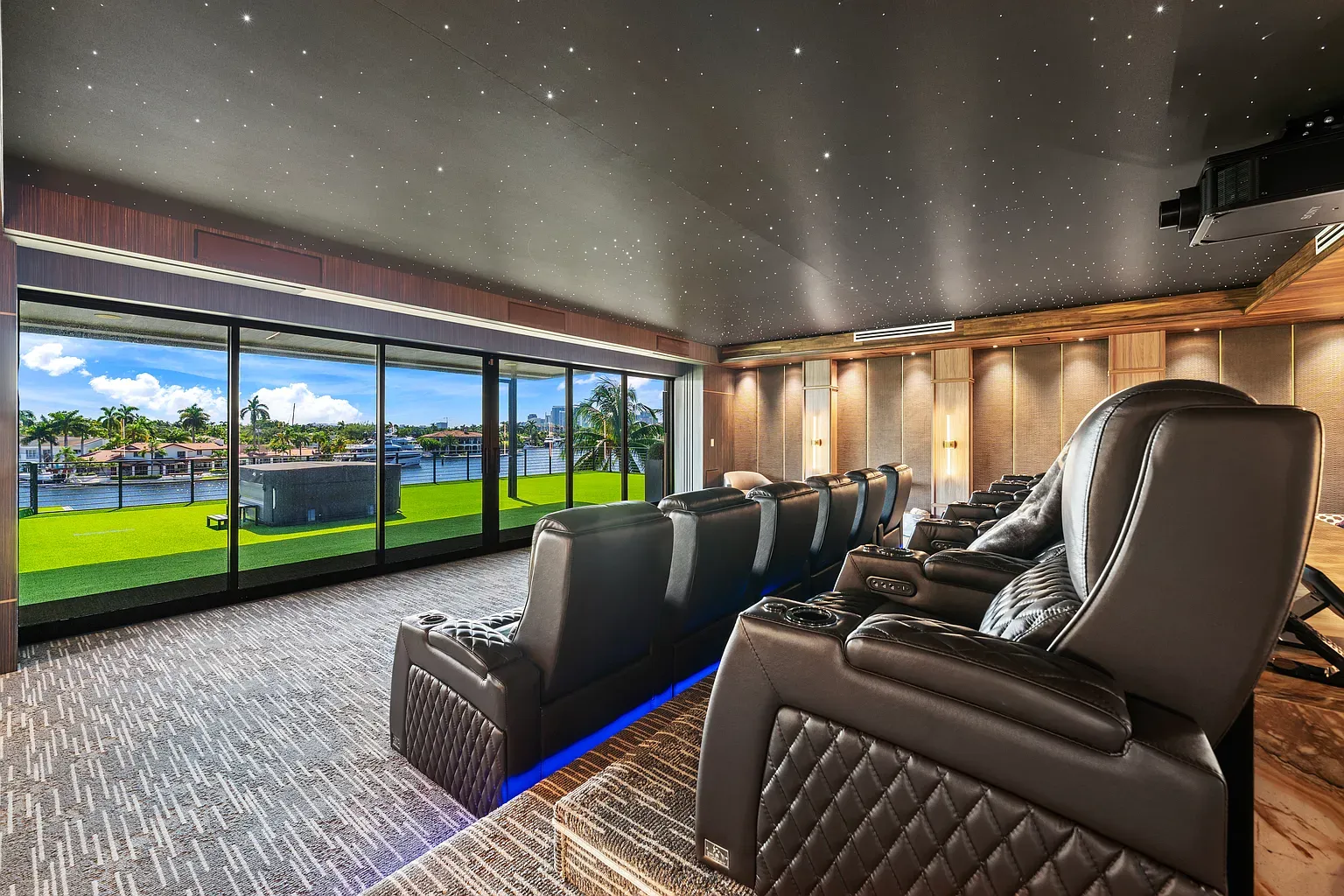 Theater room going full dark mode. Leather chairs look ridiculously comfy.