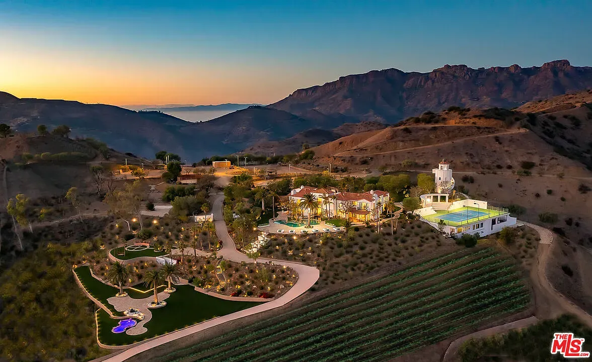 Back outside, sprawling estate. Mediterranean bones. From this angle, terraces stack nicely.