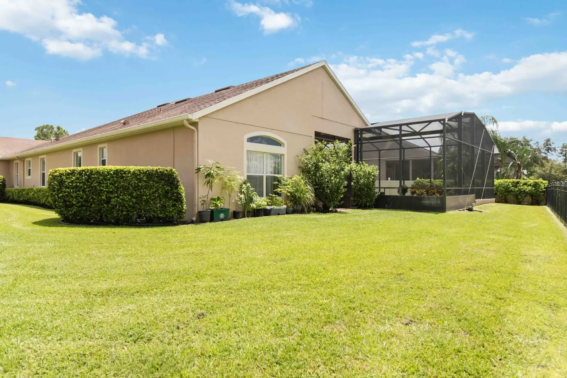 Back outside—soft beige facade, dark roof, tidy yard. Classic suburban comfort.
