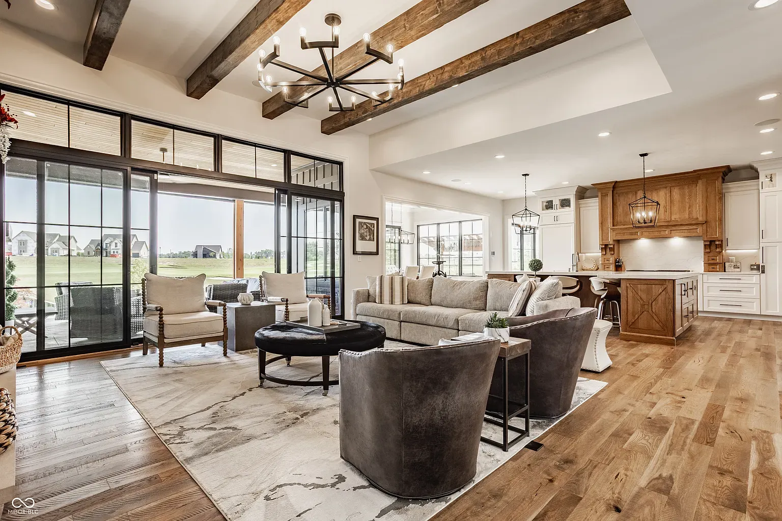 Those beams make the room. Massive sliders bring the backyard straight in.