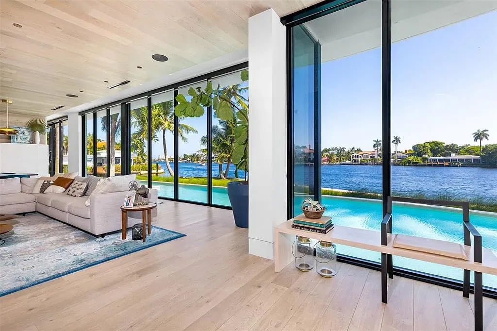 Soft woods, creamy walls, glass everywhere. Quiet money whispering, I’d live here.