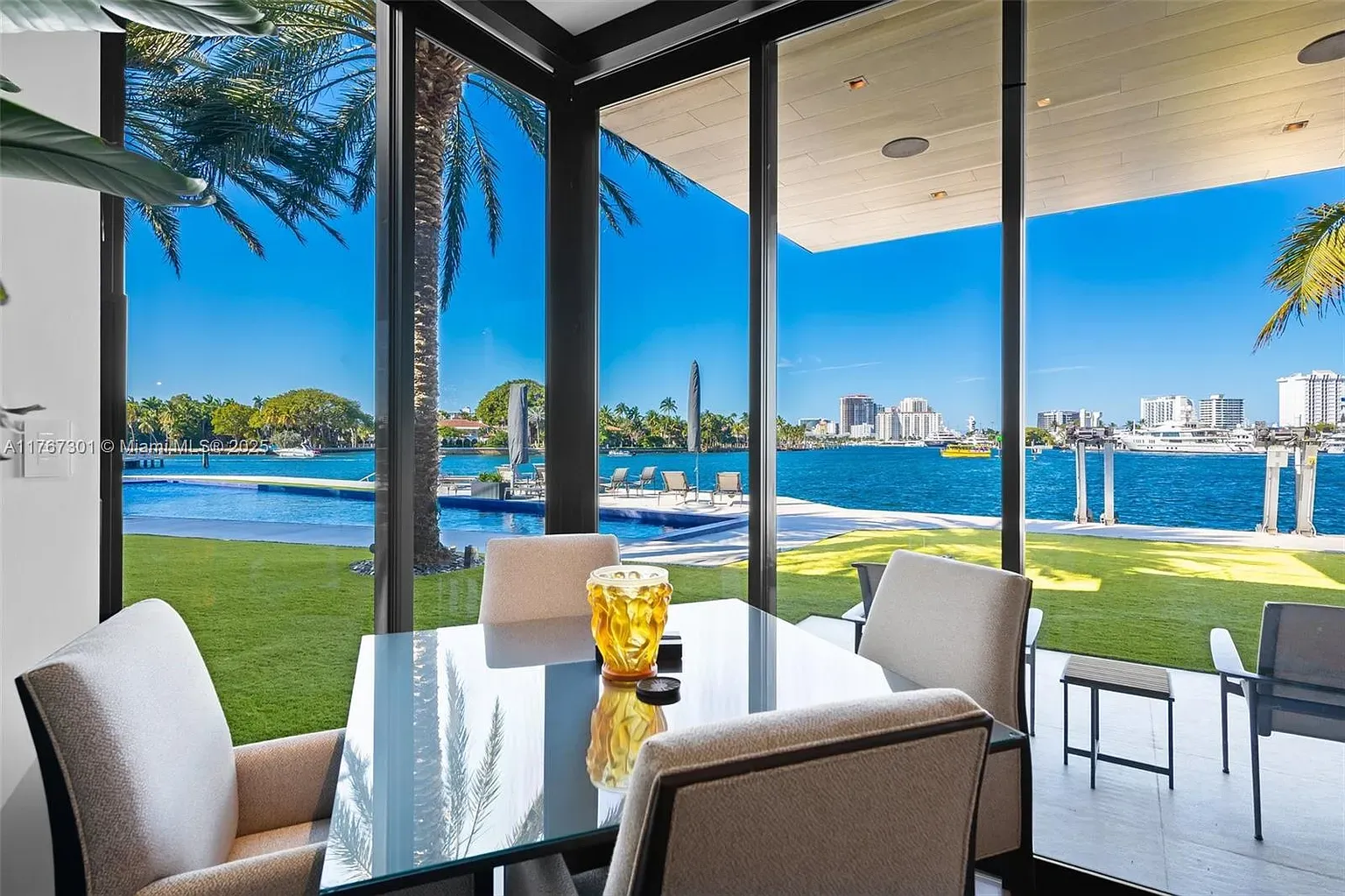 Dining with glass walls straight to the bay. Minimal decor, maximum view.